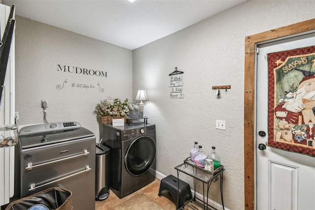 laundry area with light tile patterned flooring and washer and clothes dryer