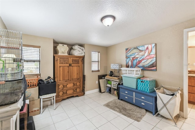 interior space featuring a textured ceiling and light tile patterned floors