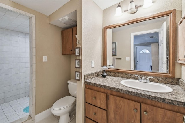 bathroom with vanity, walk in shower, tile patterned floors, and toilet