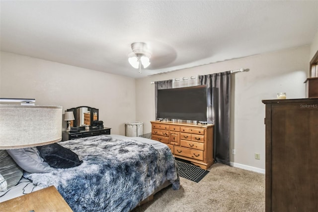 carpeted bedroom with ceiling fan and a textured ceiling