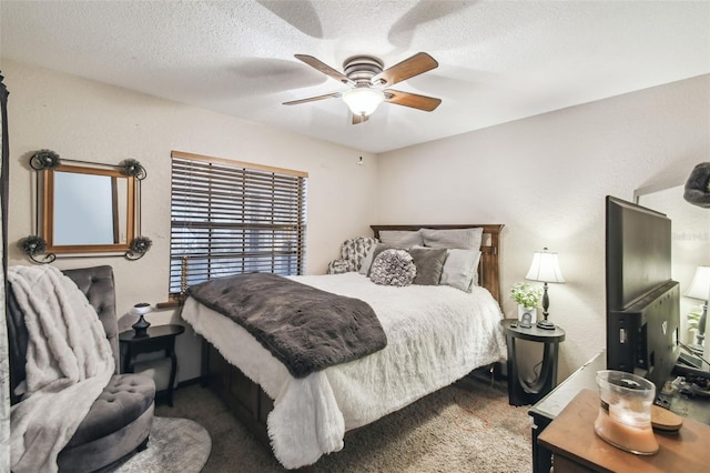 carpeted bedroom featuring ceiling fan and a textured ceiling