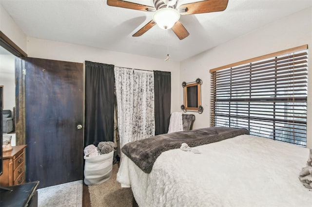 bedroom with ceiling fan and a textured ceiling