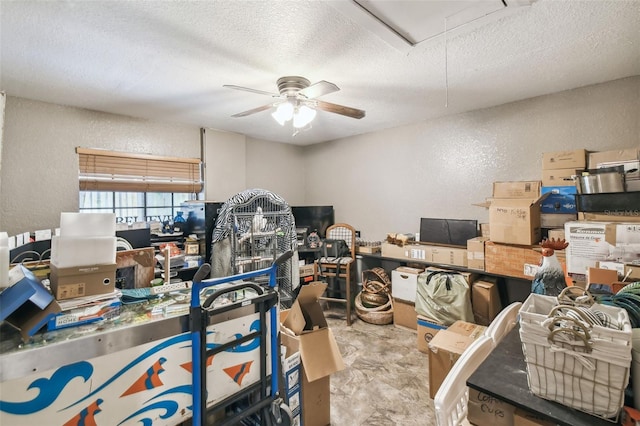 home office featuring ceiling fan and a textured ceiling