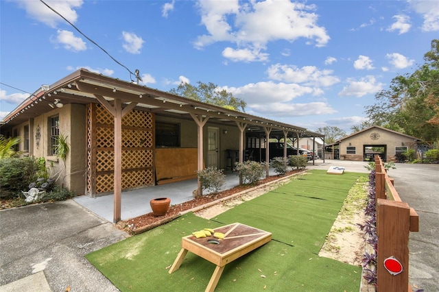 rear view of house with an outdoor structure