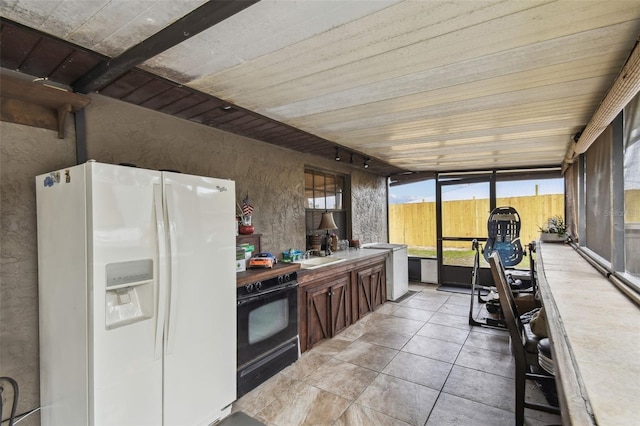 kitchen with wood ceiling, white refrigerator with ice dispenser, oven, and light tile patterned flooring