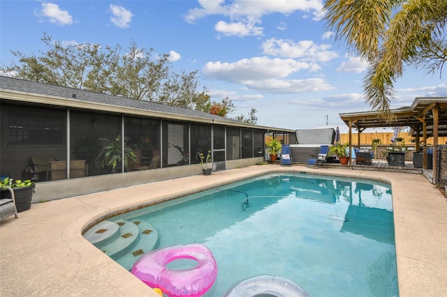 view of swimming pool featuring a patio area and a sunroom