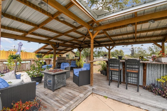 deck featuring a gazebo and an outdoor living space with a fire pit