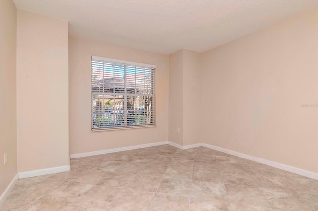 spare room with a textured ceiling