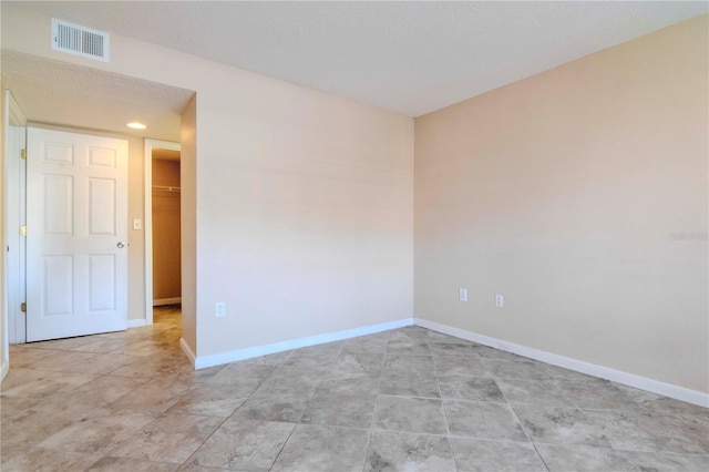 spare room featuring a textured ceiling