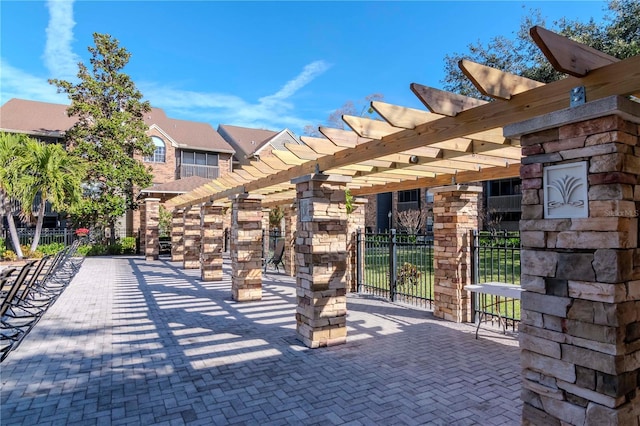 view of property's community featuring a pergola and a patio area