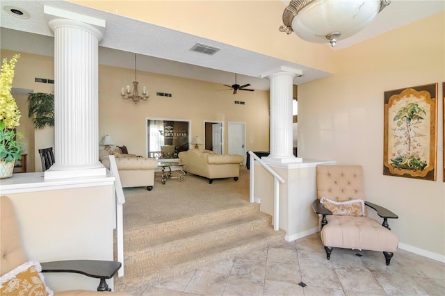 interior space featuring tile patterned flooring, ceiling fan, and ornate columns