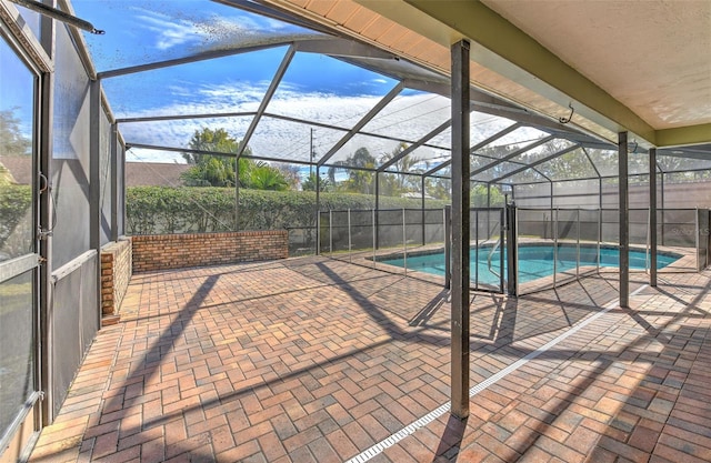 view of swimming pool featuring a patio and a lanai