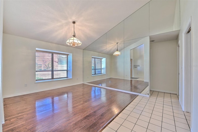 interior space with vaulted ceiling, light hardwood / wood-style flooring, and a notable chandelier