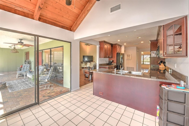 kitchen with wood ceiling, lofted ceiling with beams, stainless steel refrigerator, kitchen peninsula, and ceiling fan