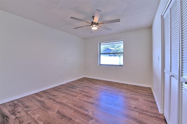 unfurnished bedroom with hardwood / wood-style flooring, ceiling fan, a textured ceiling, and a closet