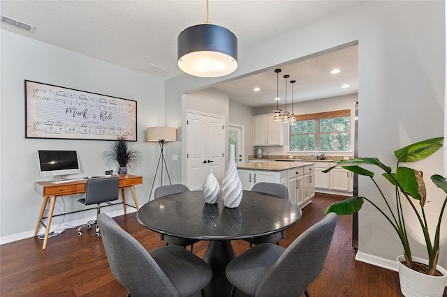 dining space featuring dark hardwood / wood-style floors