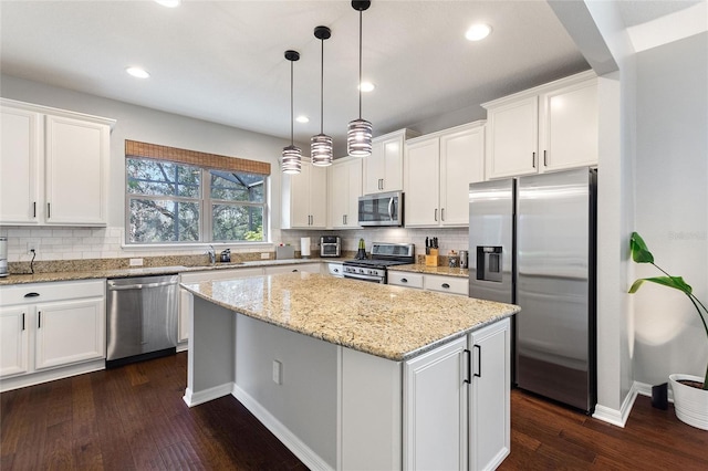 kitchen featuring white cabinetry, pendant lighting, stainless steel appliances, and a center island