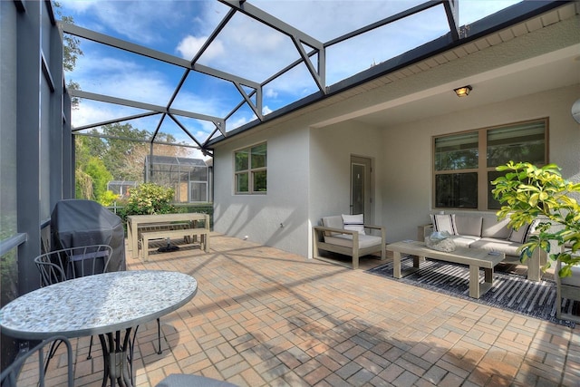 view of patio / terrace featuring grilling area, an outdoor living space, and a lanai