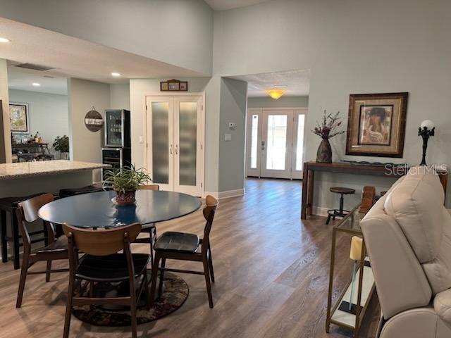 dining space featuring hardwood / wood-style flooring and french doors