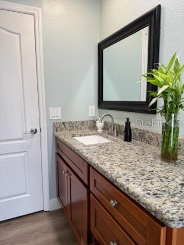 bathroom featuring vanity and hardwood / wood-style floors