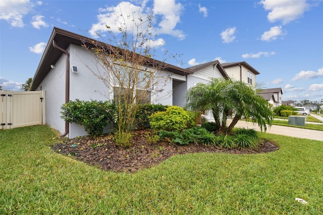 view of side of home featuring a lawn