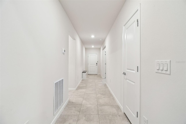 corridor featuring light tile patterned floors