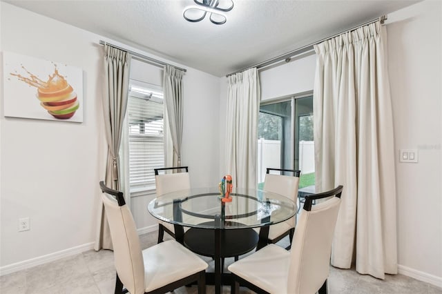 dining area featuring a textured ceiling