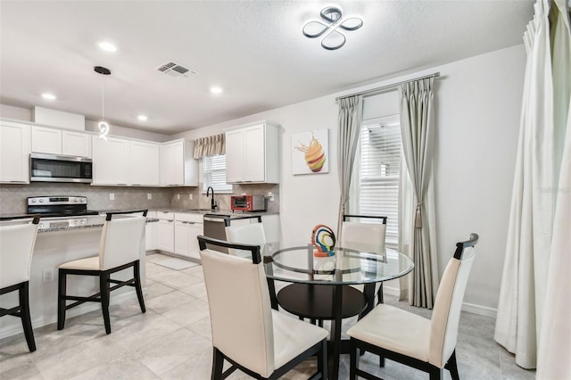 tiled dining room with sink