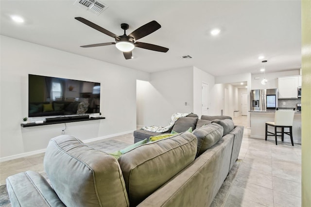 tiled living room with ceiling fan