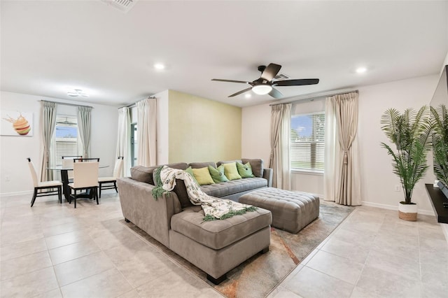 living room with light tile patterned flooring, ceiling fan, and plenty of natural light