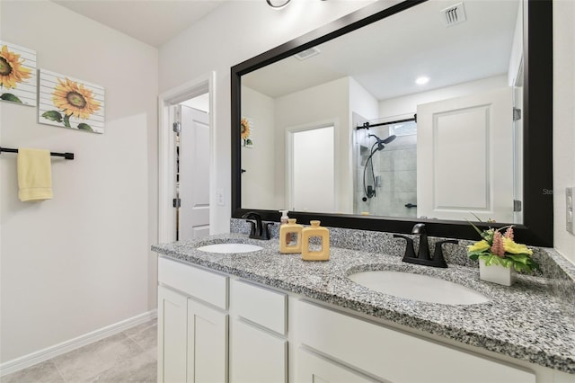 bathroom featuring walk in shower, tile patterned floors, and vanity