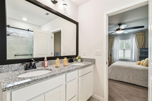 bathroom featuring walk in shower, ceiling fan, and vanity