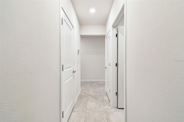 hallway featuring light tile patterned floors