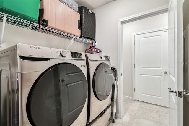 laundry room with separate washer and dryer and light tile patterned floors