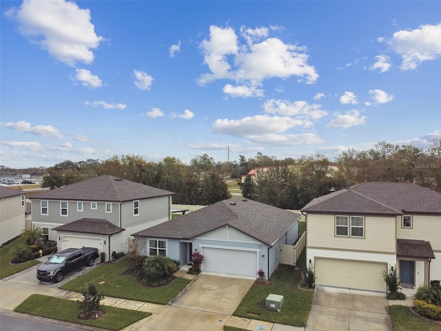 front of property with a garage and a front lawn