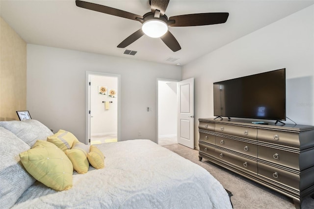 6684 Devlin Ln, Wesley Chapel, FL 33545 - carpeted bedroom with visible vents, baseboards, ceiling fan, and connected bathroom