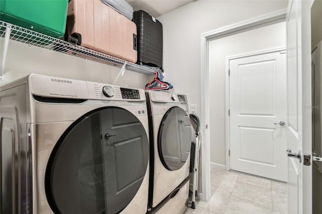 6684 Devlin Ln, Wesley Chapel, FL 33545 - washroom featuring washer and clothes dryer, laundry area, and light tile patterned flooring