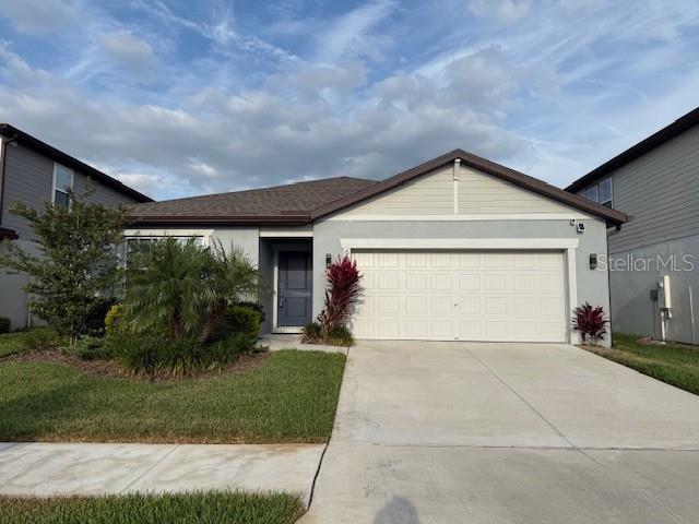 6684 Devlin Ln, Wesley Chapel, FL 33545 - ranch-style house with an attached garage and driveway