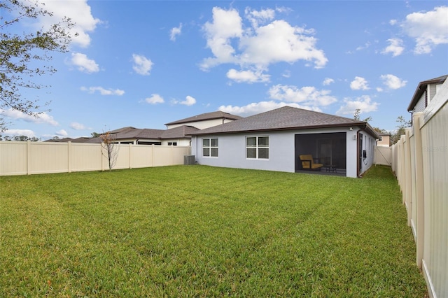 6684 Devlin Ln, Wesley Chapel, FL 33545 - rear view of property with central AC, a lawn, a fenced backyard, stucco siding, and roof with shingles