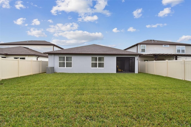 6684 Devlin Ln, Wesley Chapel, FL 33545 - back of property featuring a lawn, a sunroom, a fenced backyard, and stucco siding