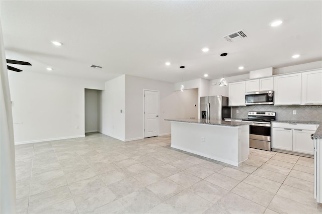 6684 Devlin Ln, Wesley Chapel, FL 33545 - kitchen featuring stainless steel appliances, a kitchen island, recessed lighting, tasteful backsplash, and stone counters