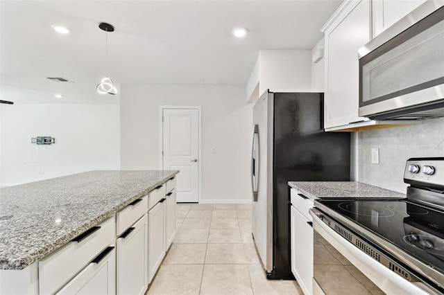 6684 Devlin Ln, Wesley Chapel, FL 33545 - kitchen with stainless steel appliances, pendant lighting, light stone countertops, tasteful backsplash, and white cabinets