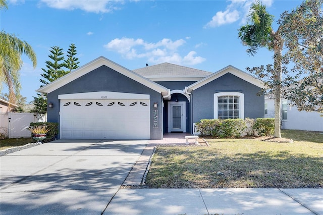 single story home featuring a garage and a front yard