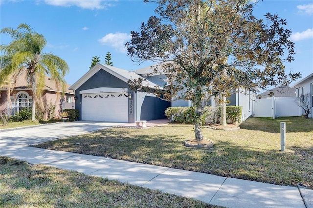 view of front of home featuring a garage and a front yard