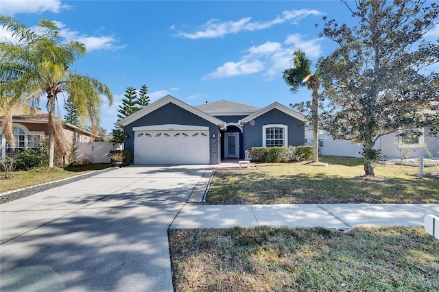 ranch-style home with a garage and a front lawn