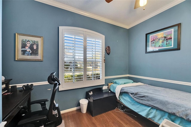 bedroom with wood-type flooring, ornamental molding, and ceiling fan