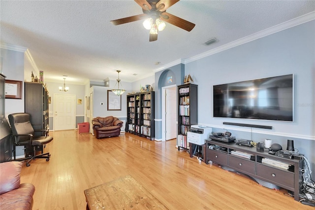 living room featuring hardwood / wood-style floors, ceiling fan with notable chandelier, ornamental molding, and a textured ceiling