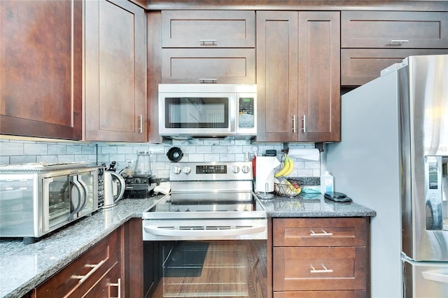 kitchen with stone counters, tasteful backsplash, and appliances with stainless steel finishes