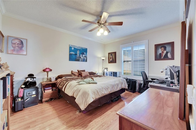 bedroom with ornamental molding, a textured ceiling, and light hardwood / wood-style flooring