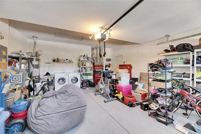 garage with a garage door opener, washer and clothes dryer, and a workshop area